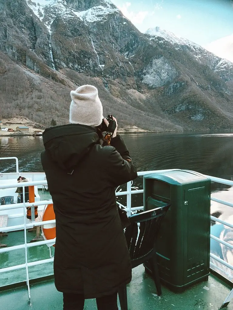 Girl photographing mountains