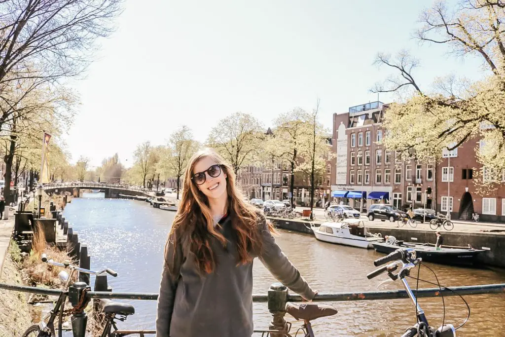 Girl in front of canal bridge in Amsterdam