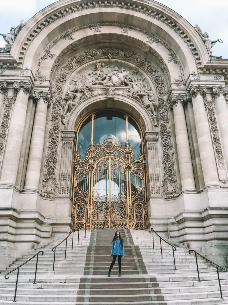 Girl in front of decorative doorway at museum in Paris