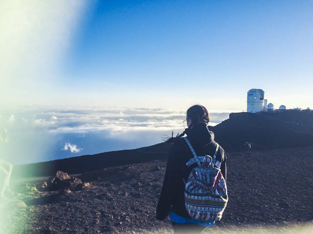 Girl looking at clouds below at Haleakala