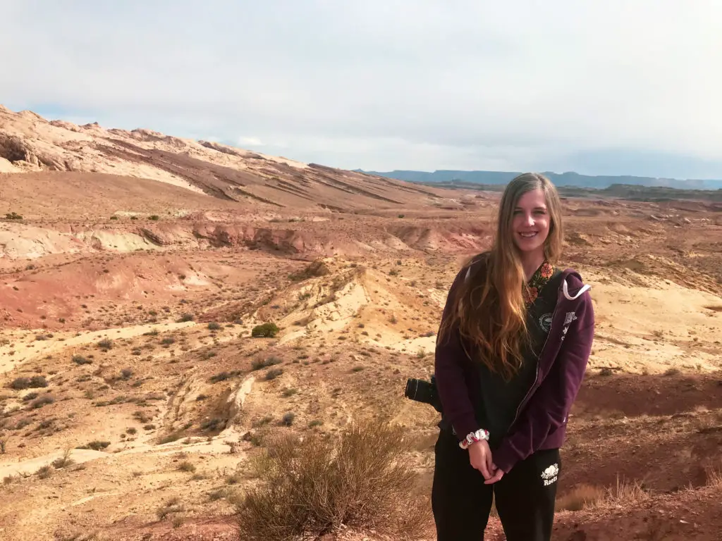 girl with camera in front of canyons in Utah