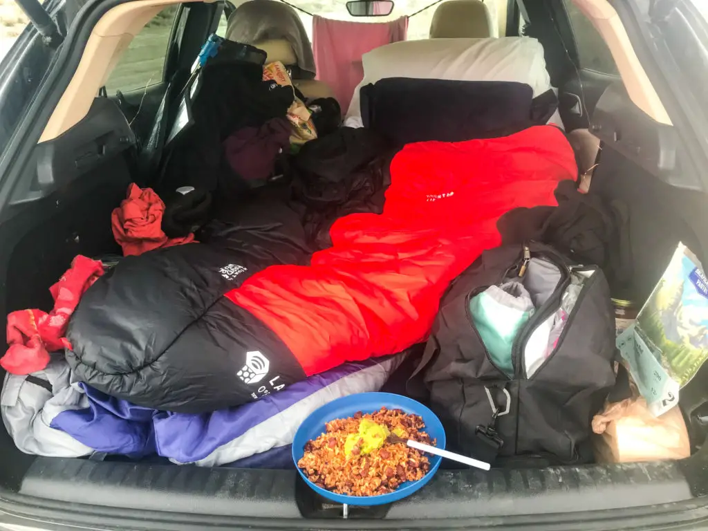 Trunk of car with sleeping bag and other car camping materials